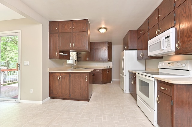 619 9th Ave, Grand Rapids, MN 55744 - kitchen with white appliances, baseboards, light countertops, and a sink