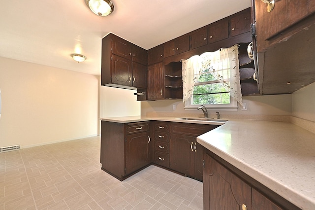 619 9th Ave, Grand Rapids, MN 55744 - kitchen with open shelves, a sink, light countertops, dark brown cabinetry, and brick patterned flooring