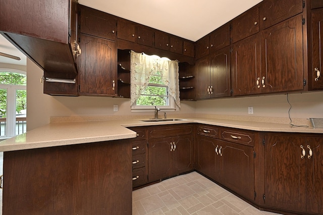 619 9th Ave, Grand Rapids, MN 55744 - kitchen with open shelves, a sink, dark brown cabinetry, and plenty of natural light
