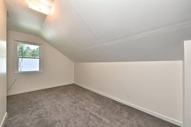 619 9th Ave, Grand Rapids, MN 55744 - additional living space featuring vaulted ceiling, carpet flooring, and baseboards