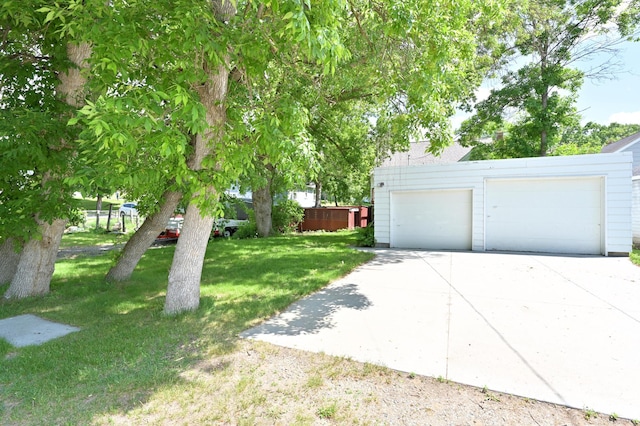 619 9th Ave, Grand Rapids, MN 55744 - view of grassy yard with a garage and driveway