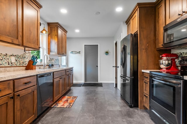 712 Shady Ln SW, Alexandria, MN 56308 - kitchen featuring stainless steel appliances, brown cabinetry, and recessed lighting