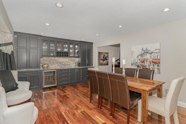 4078 153rd St W, Rosemount, MN 55068 - indoor wet bar featuring beverage cooler, dark wood-style floors, recessed lighting, backsplash, and a textured ceiling