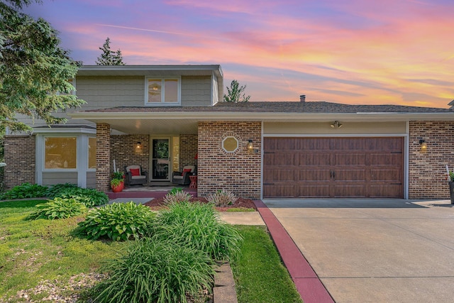 4078 153rd St W, Rosemount, MN 55068 - view of front facade with a garage, brick siding, concrete driveway, and covered porch