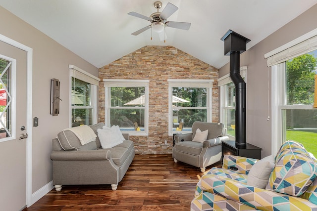 4078 153rd St W, Rosemount, MN 55068 - living room with vaulted ceiling, dark wood-style floors, brick wall, a wood stove, and a ceiling fan