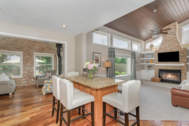 4078 153rd St W, Rosemount, MN 55068 - dining area with healthy amount of natural light, ceiling fan, a fireplace, high vaulted ceiling, and light wood-style floors