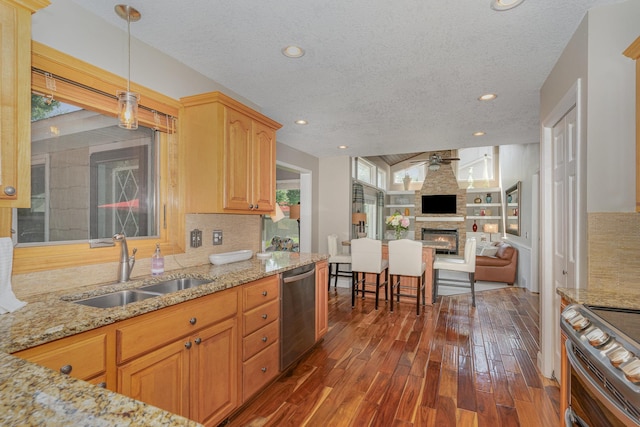 4078 153rd St W, Rosemount, MN 55068 - kitchen with stainless steel appliances, a textured ceiling, a ceiling fan, dark wood finished floors, and light stone countertops