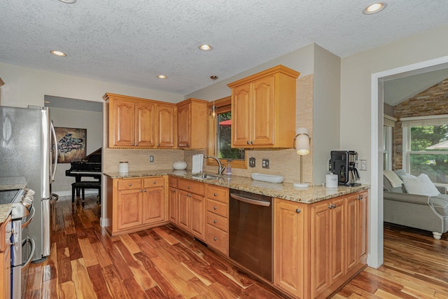4078 153rd St W, Rosemount, MN 55068 - kitchen with stainless steel appliances, light wood-type flooring, decorative backsplash, light stone countertops, and a textured ceiling