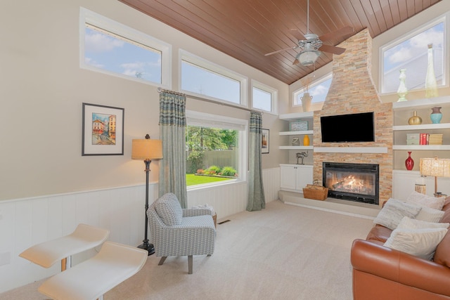 4078 153rd St W, Rosemount, MN 55068 - carpeted living room with wood ceiling, wainscoting, high vaulted ceiling, ceiling fan, and a stone fireplace