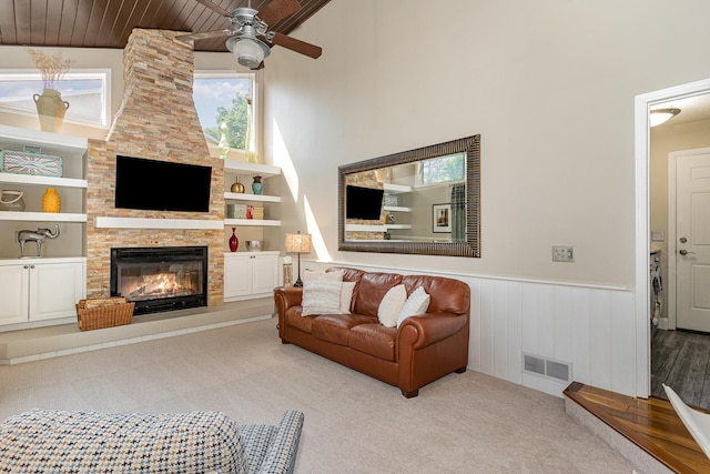 4078 153rd St W, Rosemount, MN 55068 - living area with ceiling fan, a fireplace, a wainscoted wall, a towering ceiling, and wooden ceiling