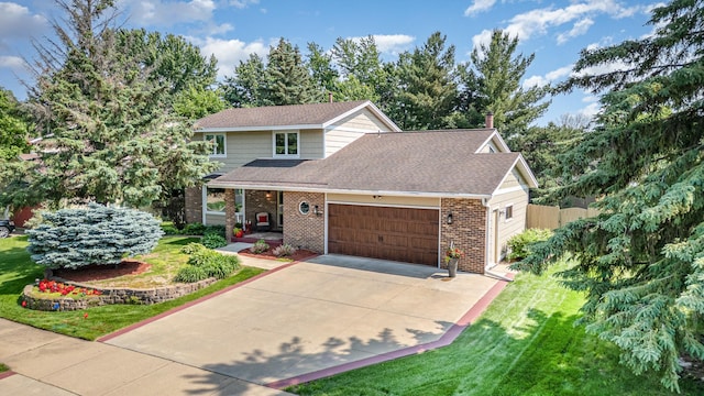 4078 153rd St W, Rosemount, MN 55068 - view of front of house with brick siding, a garage, a front yard, and driveway