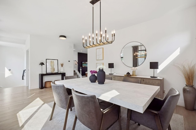 4968 40th St, Saint Louis Park, MN 55416 - dining space featuring light wood-type flooring, a chandelier, and stairway
