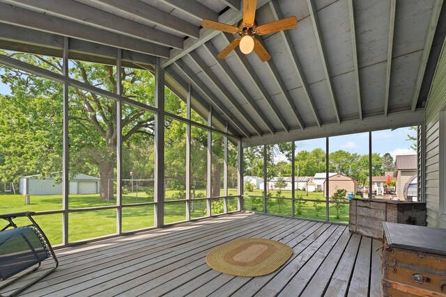 115 Spruce St W, Grey Eagle, MN 56336 - unfurnished sunroom featuring vaulted ceiling, ceiling fan, and view of scattered trees