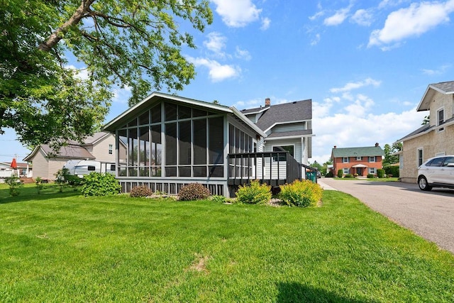 115 Spruce St W, Grey Eagle, MN 56336 - back of house with a sunroom and a lawn