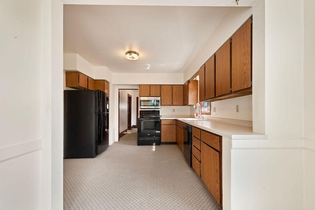 115 Spruce St W, Grey Eagle, MN 56336 - kitchen with black appliances, brown cabinets, light countertops, and light carpet