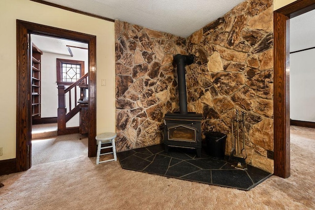 115 Spruce St W, Grey Eagle, MN 56336 - detailed view of carpet flooring, a wood stove, and a textured ceiling