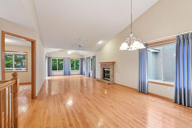 1040 Primrose Ln, Waconia, MN 55387 - unfurnished living room with vaulted ceiling, a chandelier, light wood-style floors, and a ceiling fan