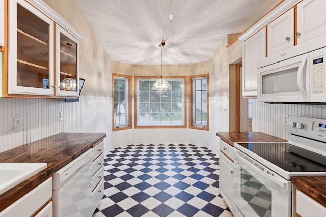 1040 Primrose Ln, Waconia, MN 55387 - kitchen featuring white appliances, light flooring, a chandelier, glass insert cabinets, and white cabinetry