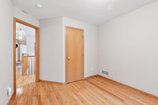 1040 Primrose Ln, Waconia, MN 55387 - unfurnished bedroom featuring light wood-type flooring and a textured ceiling