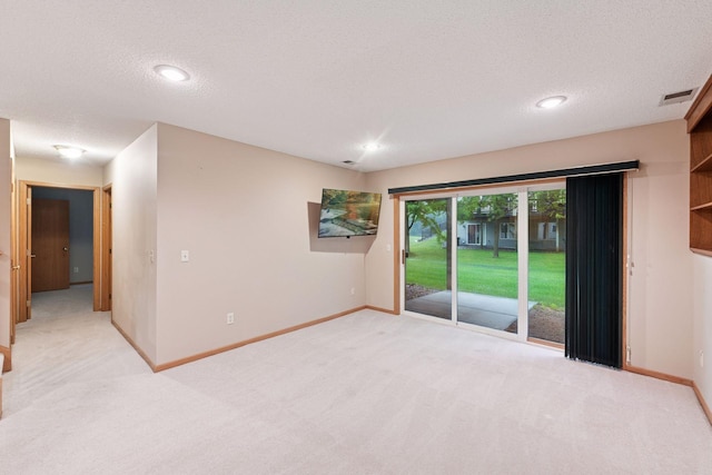 1040 Primrose Ln, Waconia, MN 55387 - spare room featuring light carpet, a textured ceiling, and recessed lighting