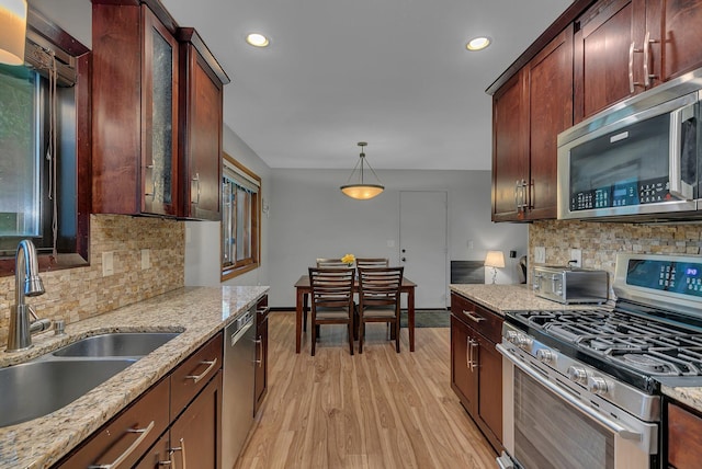 12940 8th Ave N, Zimmerman, MN 55398 - kitchen featuring stainless steel appliances, light wood-style flooring, backsplash, light stone countertops, and recessed lighting