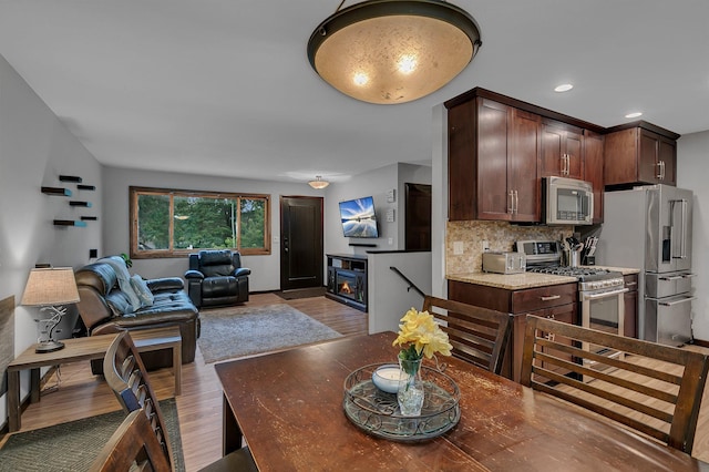 12940 8th Ave N, Zimmerman, MN 55398 - dining space featuring wood finished floors, recessed lighting, and a fireplace