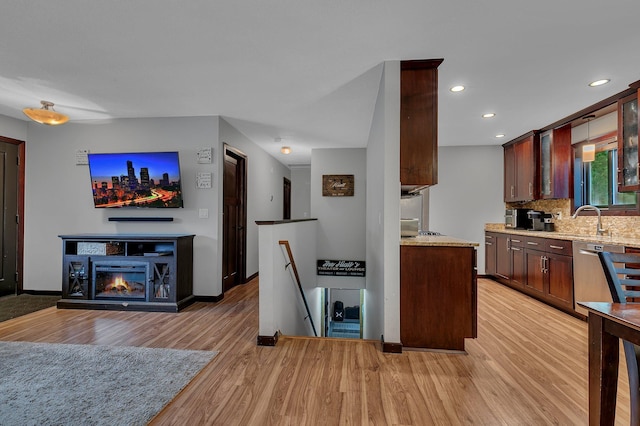 12940 8th Ave N, Zimmerman, MN 55398 - kitchen featuring light wood-style floors, stainless steel dishwasher, light stone countertops, backsplash, and recessed lighting