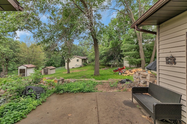 12940 8th Ave N, Zimmerman, MN 55398 - view of green lawn featuring a patio area, a shed, and view of wooded area