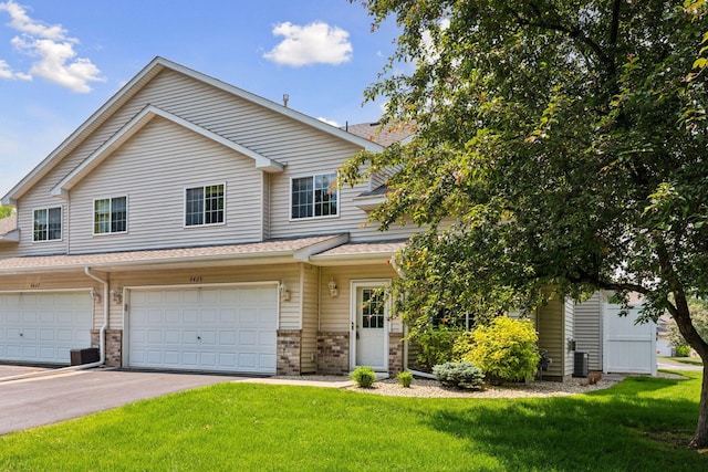 5425 Fawn Ct SE, Prior Lake, MN 55372 - view of property with a front yard, a garage, asphalt driveway, and brick siding
