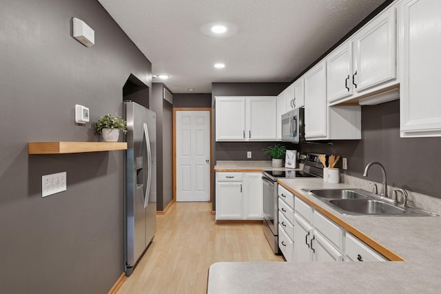 5425 Fawn Ct SE, Prior Lake, MN 55372 - kitchen featuring appliances with stainless steel finishes, light wood-style floors, white cabinetry, light countertops, and recessed lighting