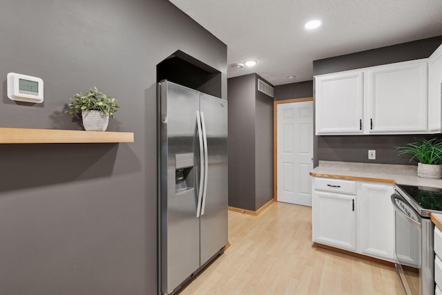 5425 Fawn Ct SE, Prior Lake, MN 55372 - kitchen with stainless steel appliances, white cabinets, light wood-type flooring, light countertops, and recessed lighting