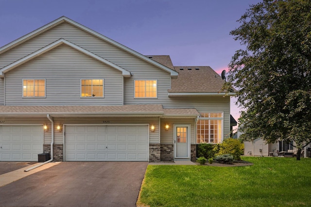 5425 Fawn Ct SE, Prior Lake, MN 55372 - townhome / multi-family property with a front yard, asphalt driveway, an attached garage, and roof with shingles
