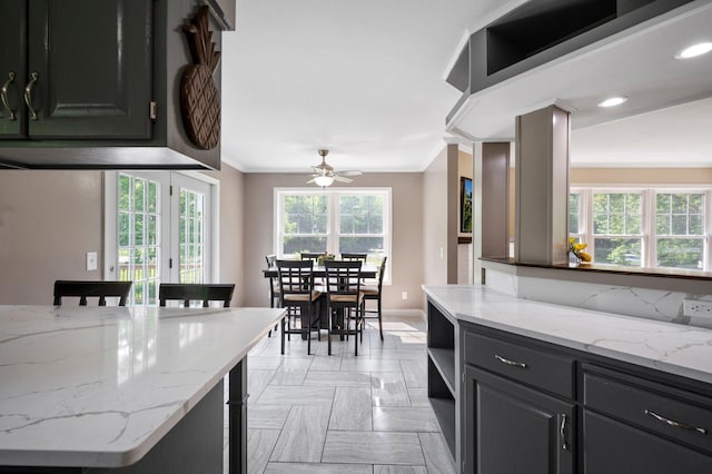 13912 80th St NE, Otsego, MN 55330 - kitchen with crown molding, baseboards, a ceiling fan, light stone countertops, and open shelves