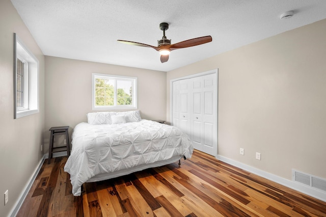13912 80th St NE, Otsego, MN 55330 - bedroom with baseboards, wood finished floors, a closet, and ceiling fan