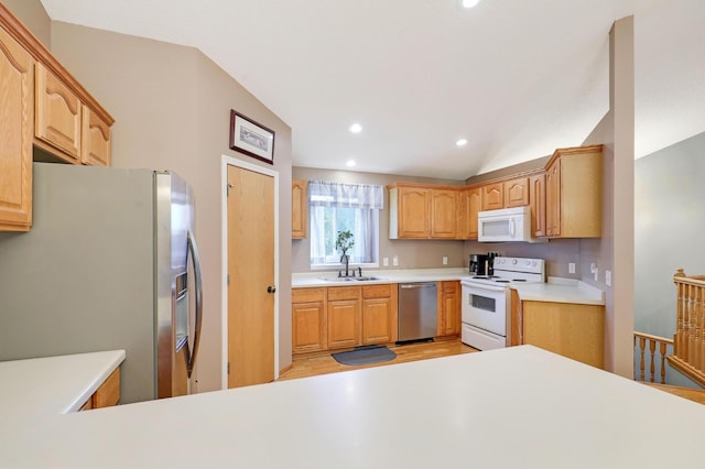 1310 Widgeon Way, Buffalo, MN 55313 - kitchen featuring stainless steel appliances, light wood finished floors, vaulted ceiling, light countertops, and recessed lighting
