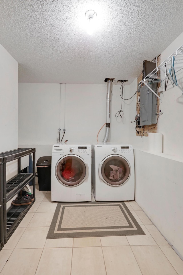 1310 Widgeon Way, Buffalo, MN 55313 - laundry area featuring independent washer and dryer, a textured ceiling, electric panel, and tile patterned flooring