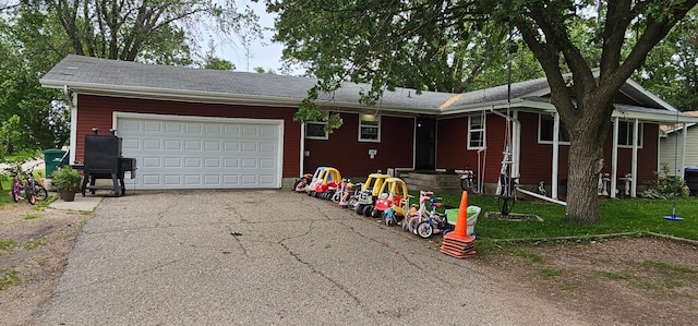 210 E St S, Underwood, MN 56586 - ranch-style house with asphalt driveway and an attached garage