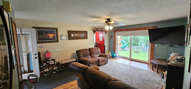 210 E St S, Underwood, MN 56586 - living room featuring wood finished floors, a ceiling fan, and a textured ceiling