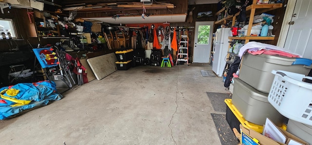 210 E St S, Underwood, MN 56586 - garage featuring freestanding refrigerator and a workshop area