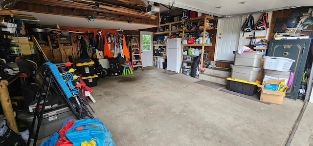 210 E St S, Underwood, MN 56586 - garage with freestanding refrigerator, a garage door opener, and a workshop area