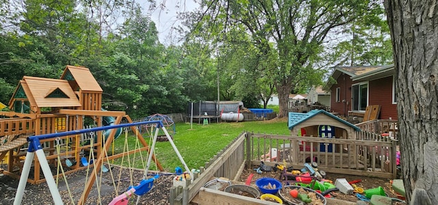210 E St S, Underwood, MN 56586 - view of grassy yard with a playground and a trampoline