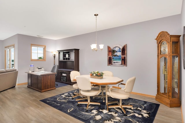 4100 Spring St Unit 310, Spring Park, MN 55384 - dining area with light wood-style flooring and a chandelier