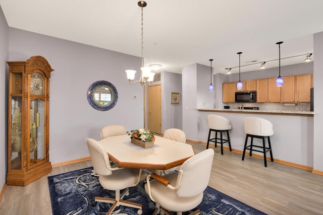 4100 Spring St Unit 310, Spring Park, MN 55384 - dining area featuring light wood-style flooring and a chandelier