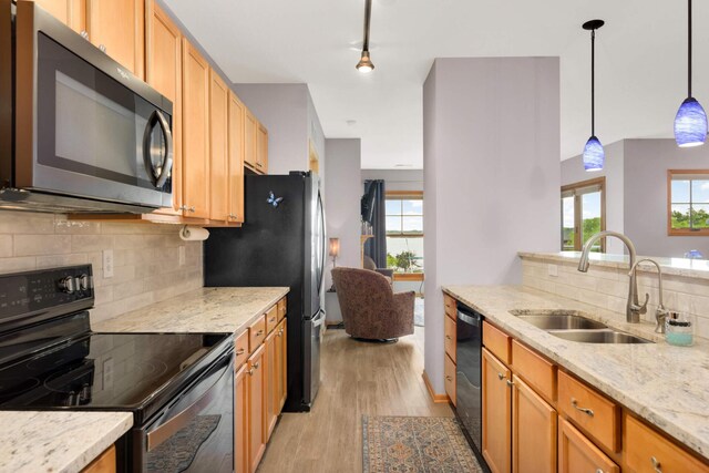 4100 Spring St Unit 310, Spring Park, MN 55384 - kitchen featuring stainless steel appliances, light wood finished floors, tasteful backsplash, and plenty of natural light
