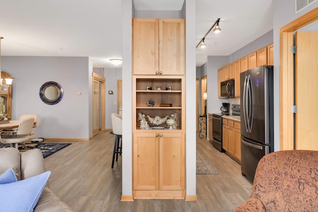 4100 Spring St Unit 310, Spring Park, MN 55384 - kitchen with electric range oven, freestanding refrigerator, black microwave, and light brown cabinetry