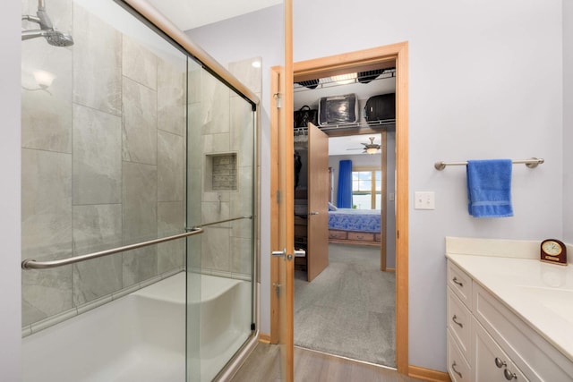 4100 Spring St Unit 310, Spring Park, MN 55384 - bathroom with ensuite bath, a ceiling fan, a stall shower, and vanity