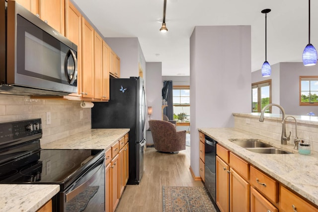 4100 Spring St Unit 310, Spring Park, MN 55384 - kitchen with appliances with stainless steel finishes, light wood-style floors, backsplash, and plenty of natural light