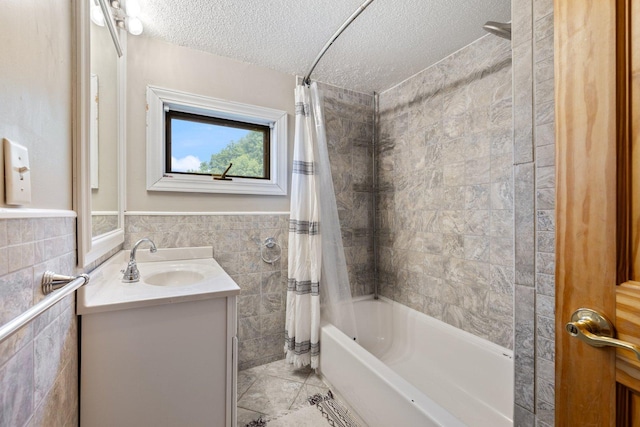 1412 11th St S, Virginia, MN 55792 - bathroom featuring a textured ceiling, shower / bath combo with shower curtain, tile walls, vanity, and tile patterned flooring