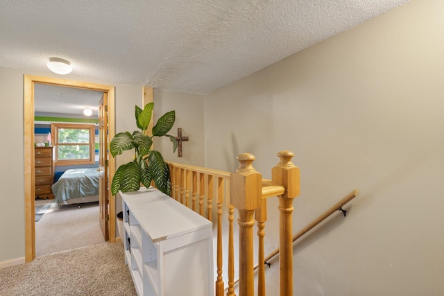1412 11th St S, Virginia, MN 55792 - hall with an upstairs landing, light colored carpet, and a textured ceiling