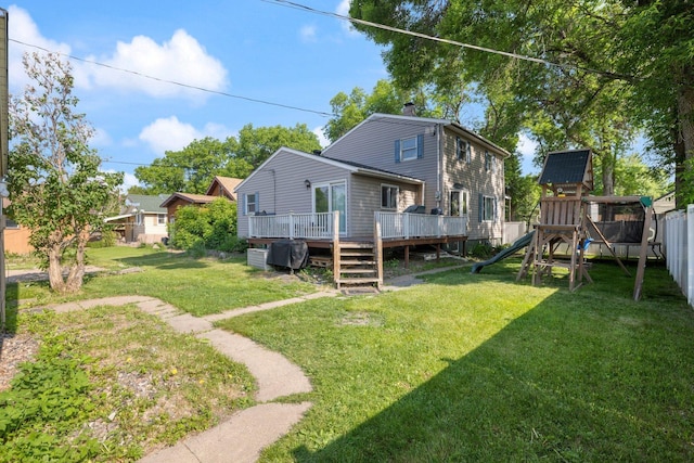 1412 11th St S, Virginia, MN 55792 - rear view of house with a playground, a chimney, and a wooden deck